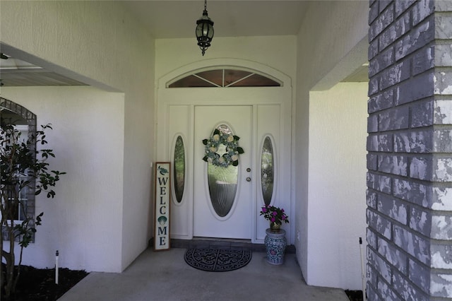 entrance to property with stucco siding