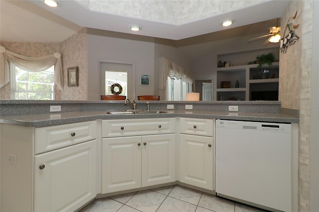 kitchen featuring a sink, light tile patterned floors, white cabinetry, and dishwasher