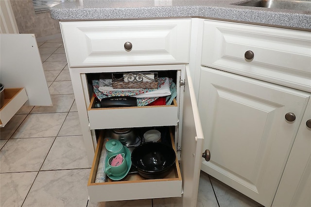 interior details featuring white cabinets and a sink