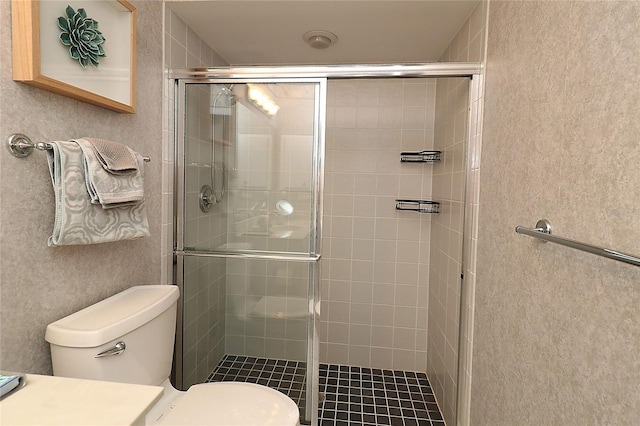 bathroom with toilet and a shower stall
