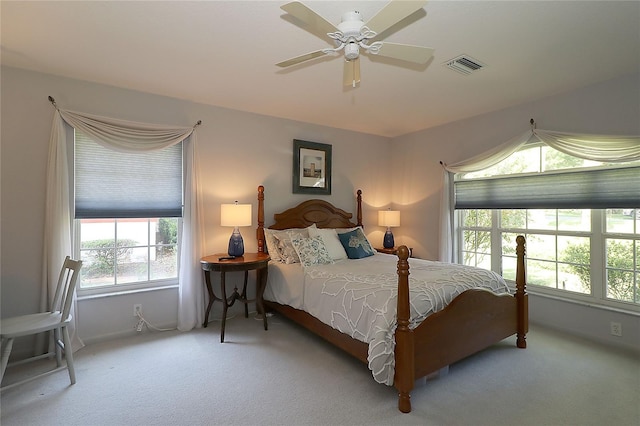 bedroom with a ceiling fan, baseboards, visible vents, and carpet