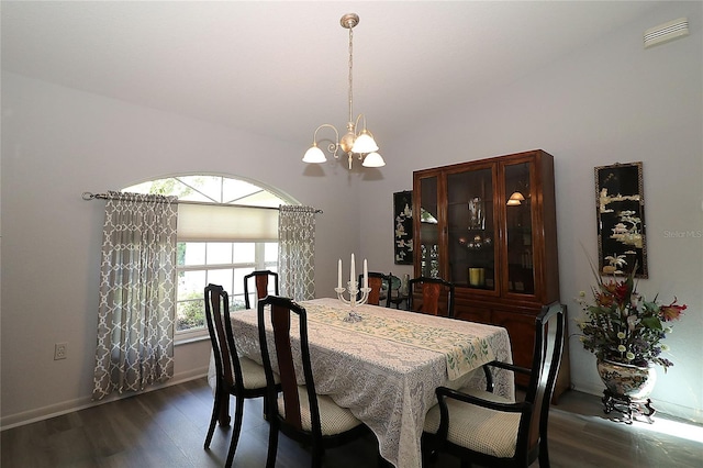 dining space with visible vents, dark wood-style flooring, lofted ceiling, baseboards, and a notable chandelier