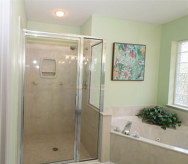 full bath with a tub with jets and a shower stall