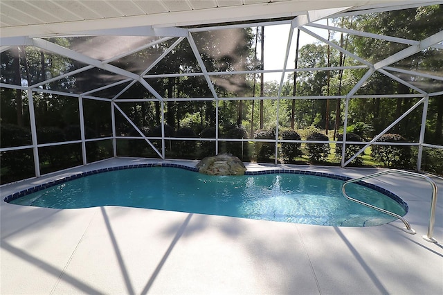pool featuring glass enclosure and a patio