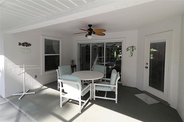 view of patio with a ceiling fan and outdoor dining area
