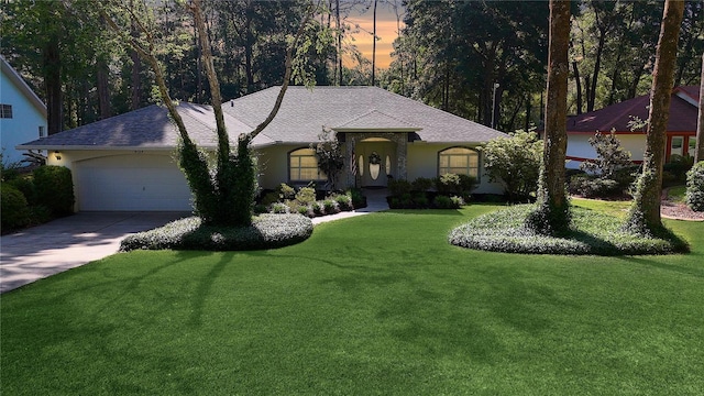 9129 SW 193rd Cir, Dunnellon, FL 34432 - single story home with an attached garage, concrete driveway, a front lawn, stucco siding, and a shingled roof