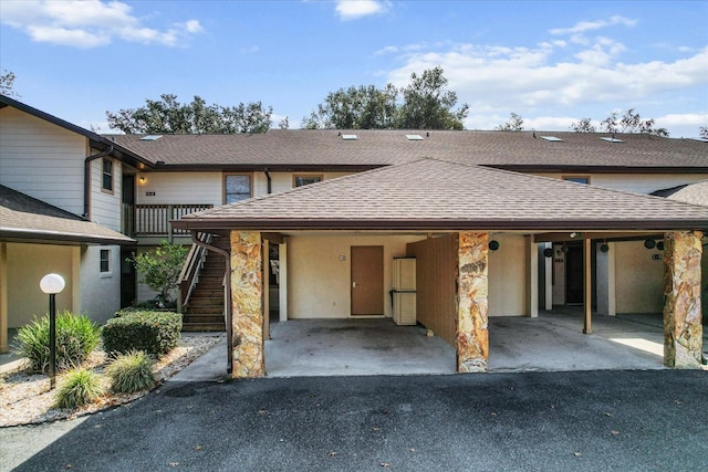 340 E Glassboro Ct Unit 4B, Hernando, FL 34442 - view of front of home with roof with shingles, stairway, and asphalt driveway