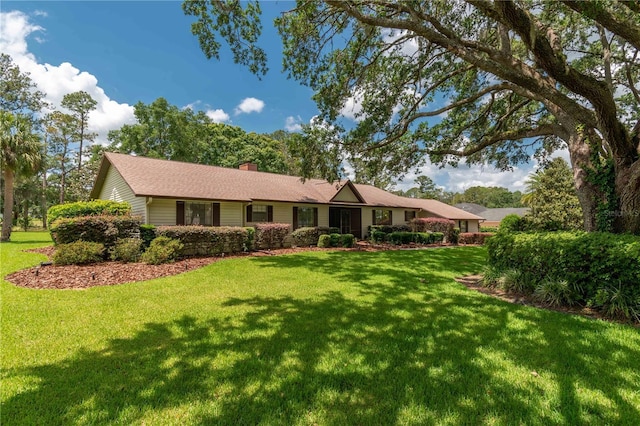 single story home featuring a front yard and a chimney