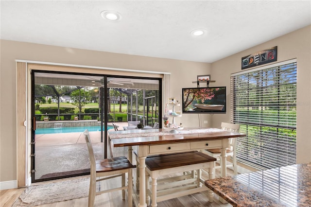 dining space featuring recessed lighting, baseboards, wood finished floors, and a wealth of natural light