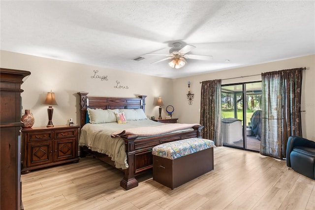 bedroom featuring a textured ceiling, access to exterior, light wood-style flooring, a ceiling fan, and visible vents