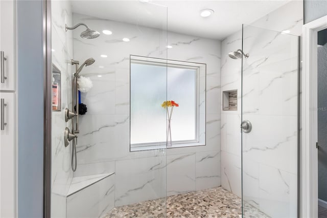 bathroom with a marble finish shower