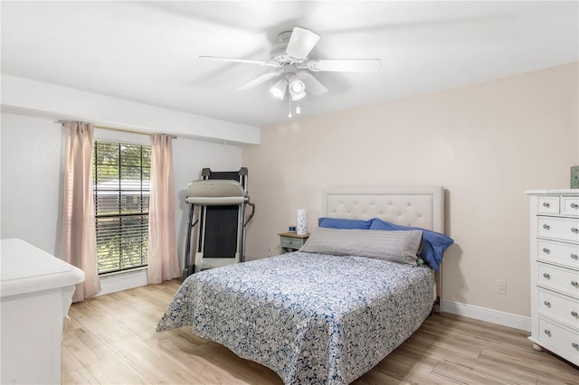 bedroom with baseboards, a ceiling fan, and light wood finished floors