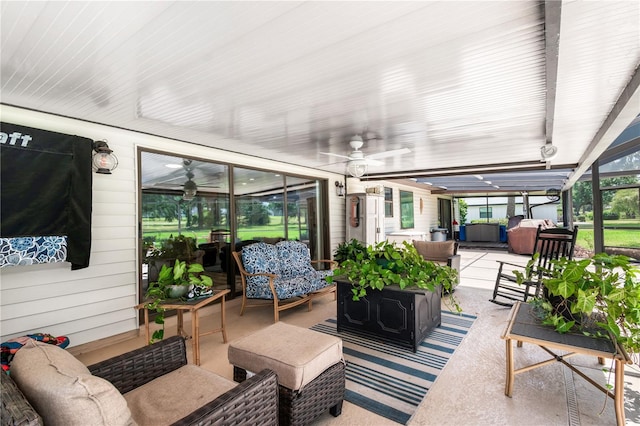exterior space featuring an outdoor hangout area and a ceiling fan