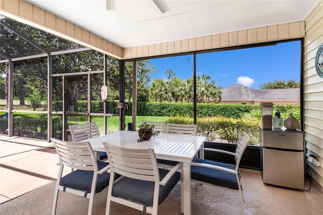 sunroom with ceiling fan and outdoor dining space