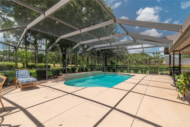 outdoor pool featuring a patio area and a lanai