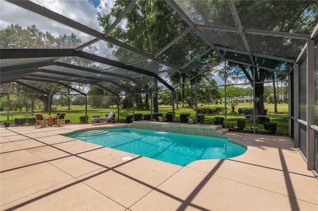 pool with glass enclosure, a yard, and a patio area