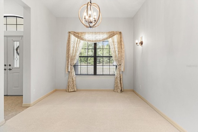 interior space featuring an inviting chandelier, carpet, and baseboards