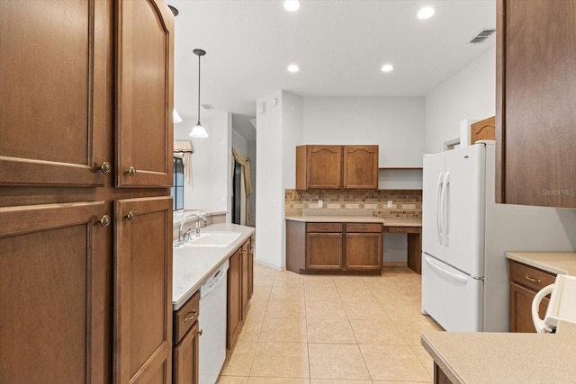kitchen with visible vents, decorative backsplash, white appliances, a sink, and light tile patterned floors