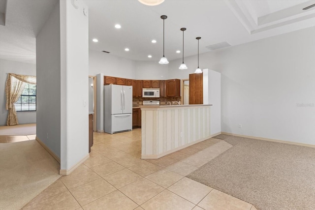 kitchen with white appliances, visible vents, light carpet, and light tile patterned floors