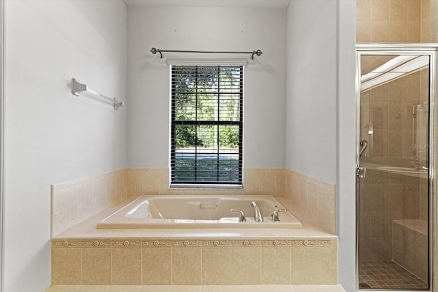 bathroom with a stall shower and a bath