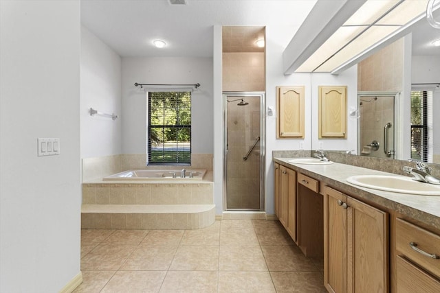 bathroom with a sink, a shower stall, and a garden tub