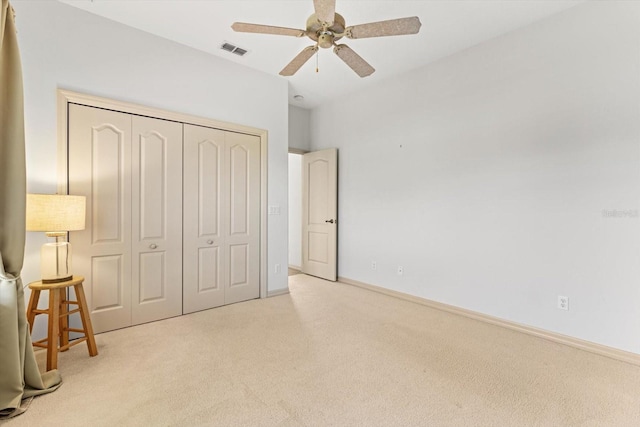 bedroom featuring visible vents, carpet flooring, a ceiling fan, and a closet
