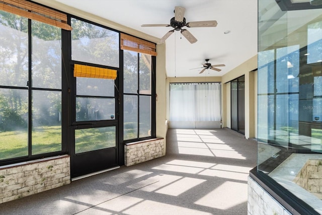 unfurnished sunroom with ceiling fan