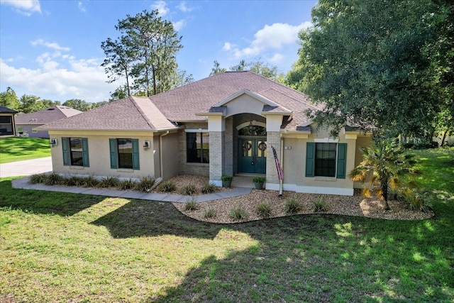 ranch-style home featuring french doors, stucco siding, and a front yard