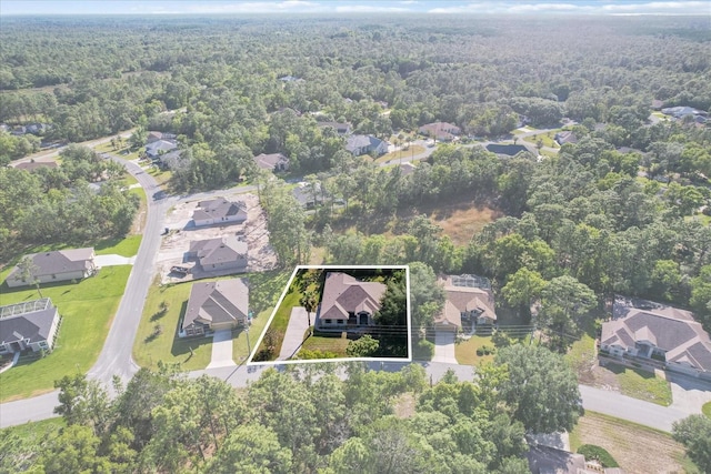 birds eye view of property featuring a residential view and a wooded view