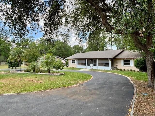 4145 SE 3rd St, Ocala, FL 34471 - single story home featuring stucco siding, driveway, and a front lawn