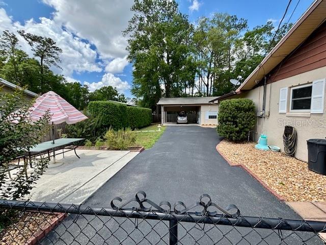4145 SE 3rd St, Ocala, FL 34471 - exterior space featuring fence, a carport, and stucco siding