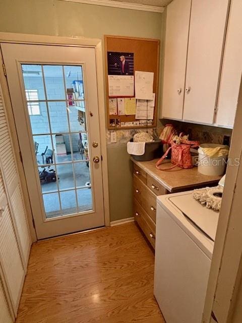 4145 SE 3rd St, Ocala, FL 34471 - laundry area with crown molding, light wood finished floors, washer / clothes dryer, and baseboards