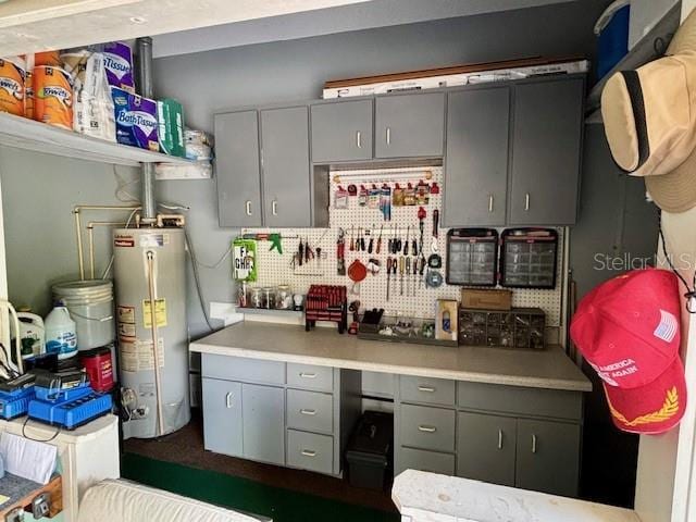 4145 SE 3rd St, Ocala, FL 34471 - kitchen featuring light countertops, gray cabinets, water heater, and decorative backsplash