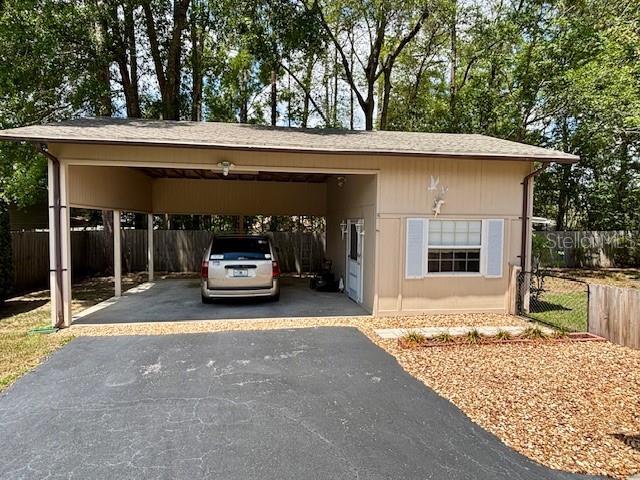 4145 SE 3rd St, Ocala, FL 34471 - view of car parking featuring fence, a carport, and aphalt driveway
