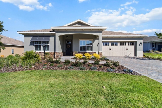 view of front of house with a garage, stone siding, a front yard, decorative driveway, and stucco siding