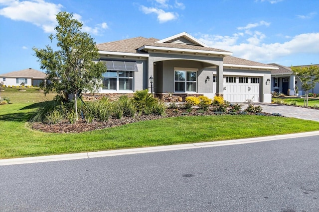 view of front of home featuring a front lawn, stone siding, a garage, stucco siding, and driveway