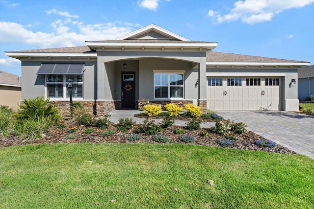 view of front of house with a garage, a front lawn, stone siding, decorative driveway, and stucco siding