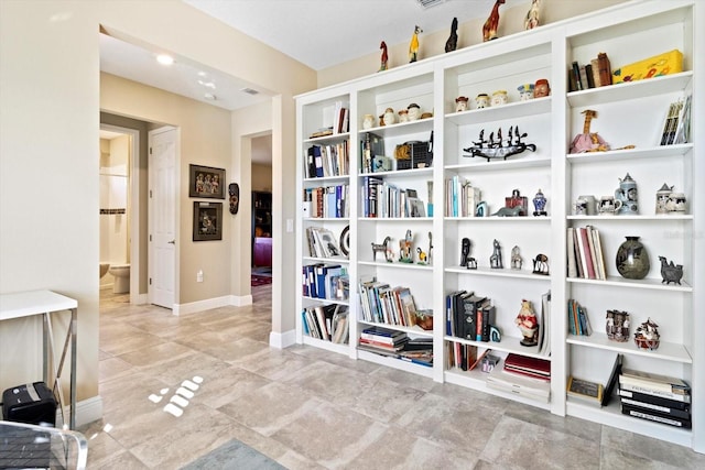 interior space with baseboards and tile patterned flooring