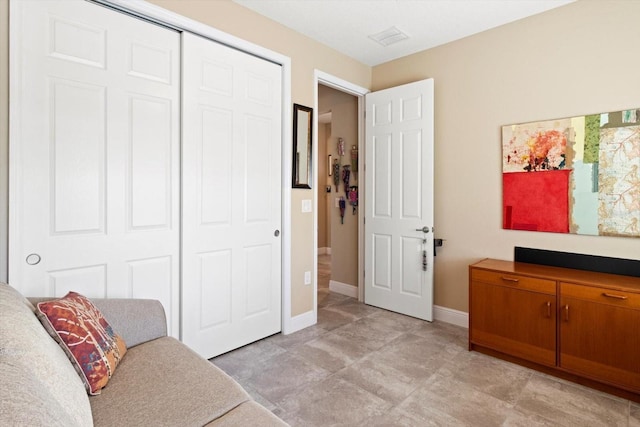 living area featuring baseboards and visible vents