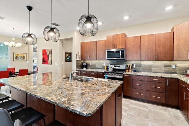 kitchen with a sink, backsplash, a breakfast bar, and stainless steel appliances