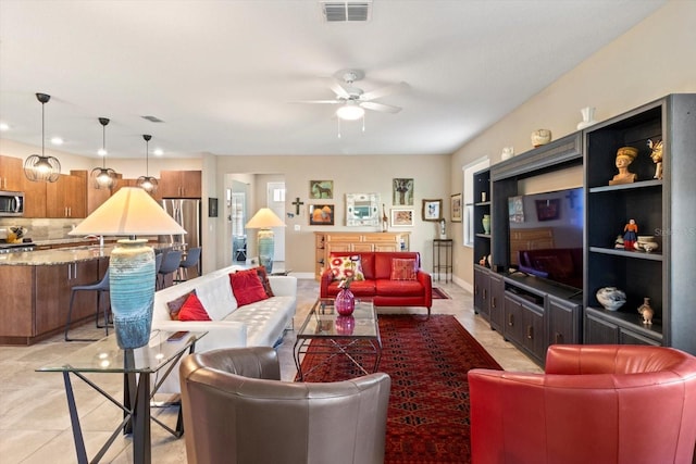 living area featuring light tile patterned floors, a ceiling fan, recessed lighting, and visible vents