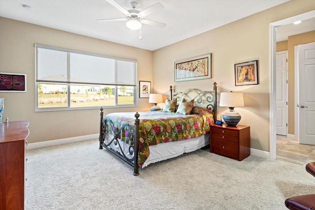 carpeted bedroom with baseboards and a ceiling fan