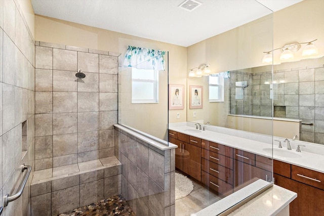 full bath featuring a sink, walk in shower, double vanity, and visible vents