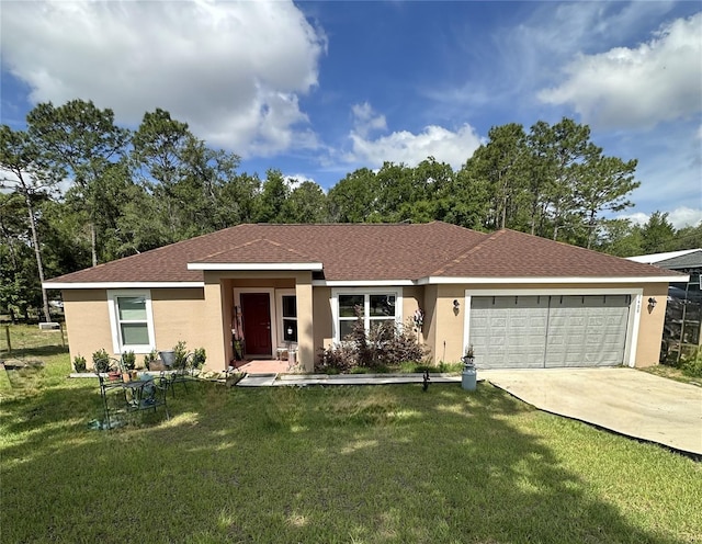 ranch-style home with a shingled roof, an attached garage, stucco siding, a front yard, and driveway