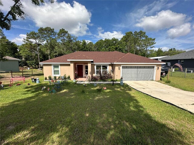 ranch-style home with an attached garage, a front lawn, driveway, and stucco siding