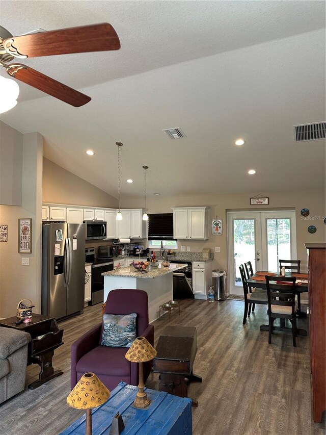 living room with recessed lighting, dark wood-style flooring, and visible vents
