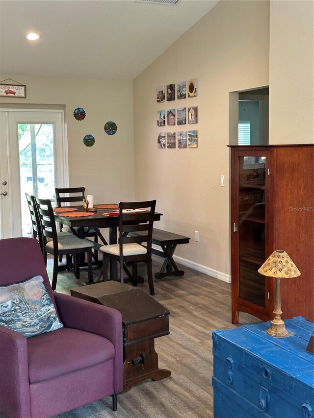 dining area featuring visible vents, wood finished floors, baseboards, recessed lighting, and vaulted ceiling