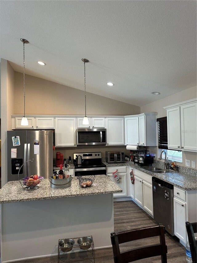 kitchen featuring a sink, lofted ceiling, white cabinets, and stainless steel appliances