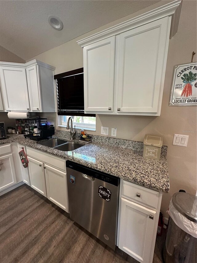 kitchen with dishwasher, a sink, light stone counters, white cabinets, and dark wood-style floors