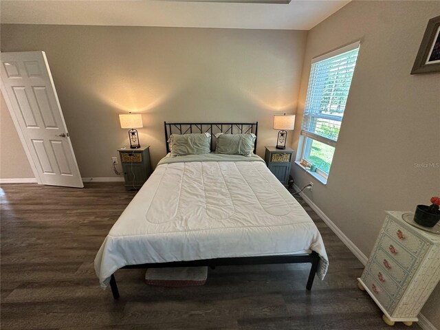 bedroom featuring baseboards and wood finished floors